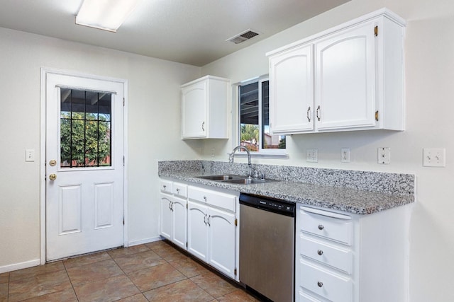 kitchen with white cabinetry, sink, stainless steel dishwasher, and light stone countertops