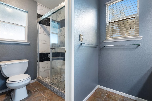 bathroom with walk in shower and toilet