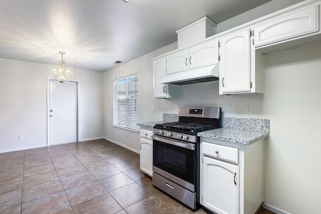 kitchen featuring stainless steel range with gas cooktop, pendant lighting, white cabinetry, light tile patterned floors, and a notable chandelier