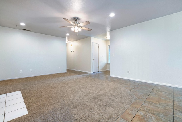 empty room with ceiling fan and carpet flooring