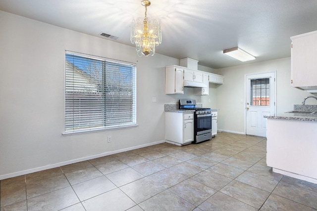 kitchen featuring pendant lighting, an inviting chandelier, stainless steel gas range oven, white cabinets, and light tile patterned flooring