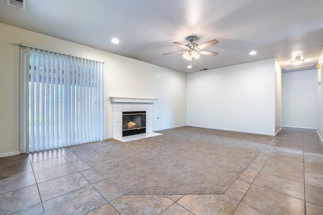 unfurnished living room featuring ceiling fan, light colored carpet, and a fireplace