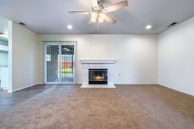 unfurnished living room featuring ceiling fan, light colored carpet, and a fireplace