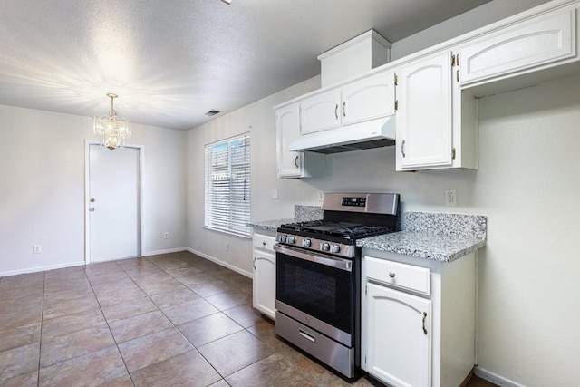 kitchen featuring white cabinets, hanging light fixtures, light tile patterned floors, stainless steel gas range, and an inviting chandelier