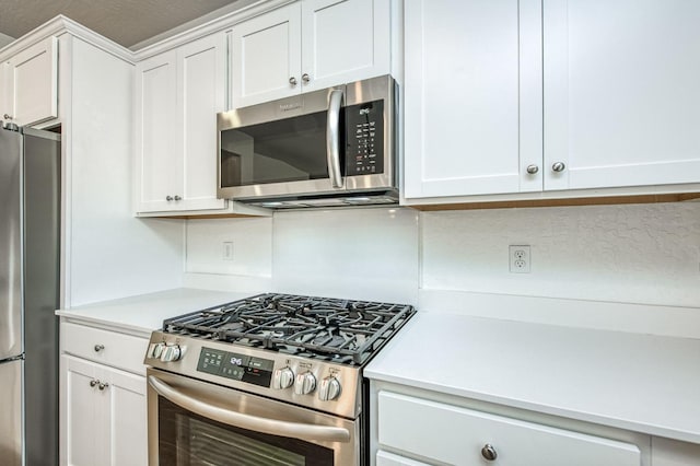 kitchen featuring white cabinetry and appliances with stainless steel finishes