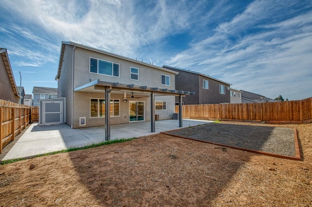 back of house featuring a storage shed and a patio area