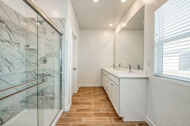 bathroom featuring vanity and a shower with shower door