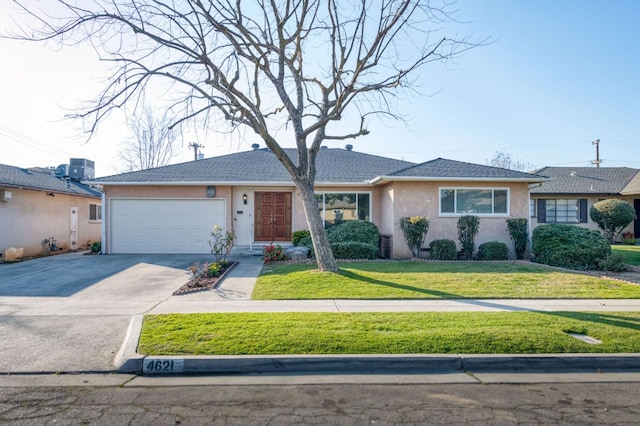 ranch-style house featuring a garage and a front yard