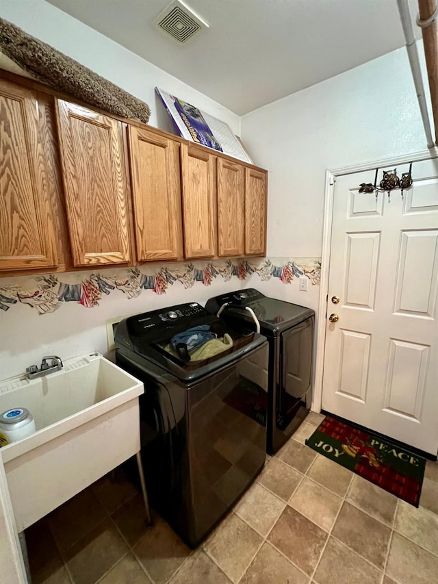 laundry area with cabinets, sink, and washing machine and clothes dryer