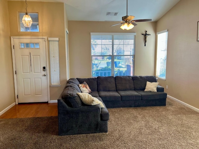 carpeted living room featuring ceiling fan