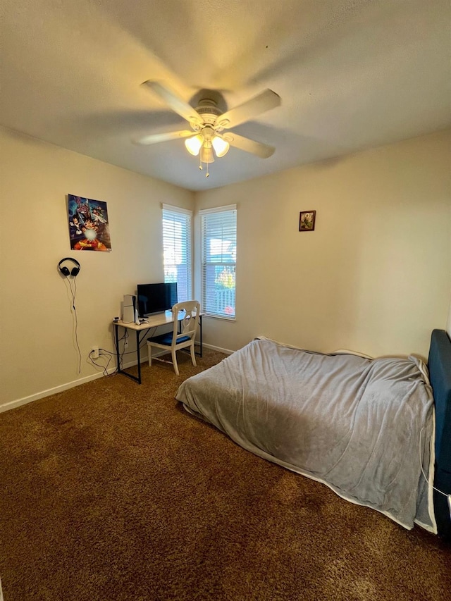 bedroom featuring ceiling fan and carpet