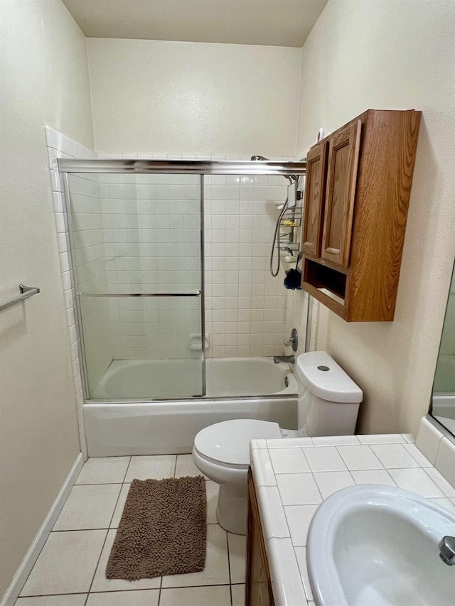 full bathroom with vanity, toilet, tile patterned flooring, and combined bath / shower with glass door