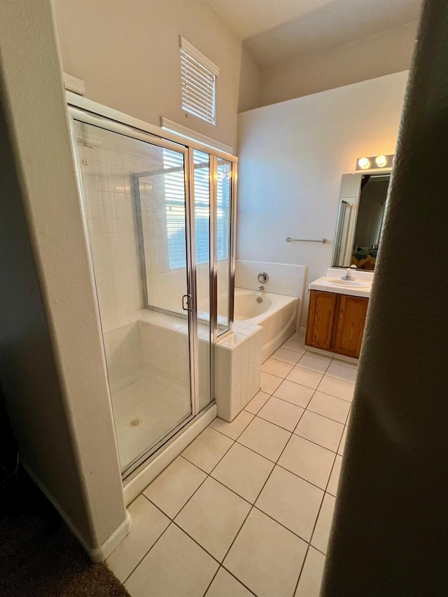 bathroom with tile patterned flooring, shower with separate bathtub, and vanity