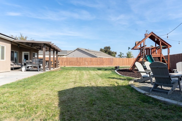 view of yard with a playground and a patio area