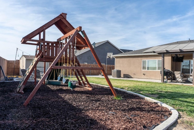 view of playground with central AC and a yard