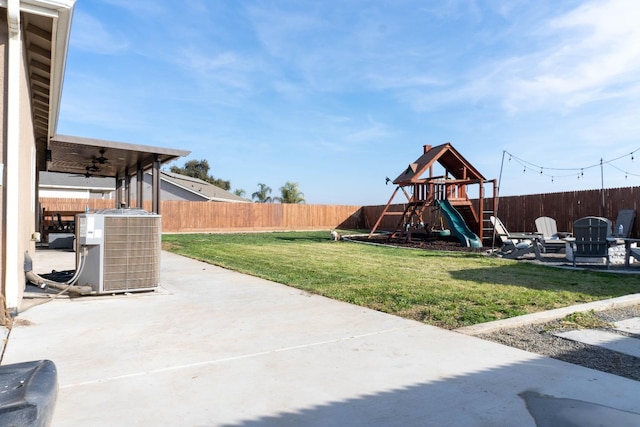 view of yard featuring central AC unit, a patio area, and a playground