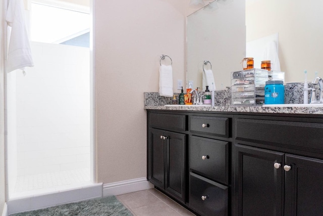 bathroom with vanity, tile patterned floors, and tiled shower