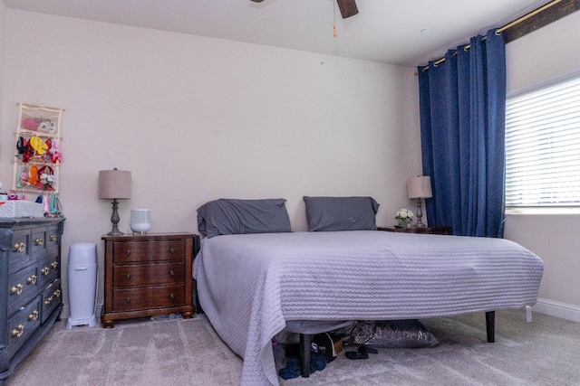 bedroom with ceiling fan and light colored carpet