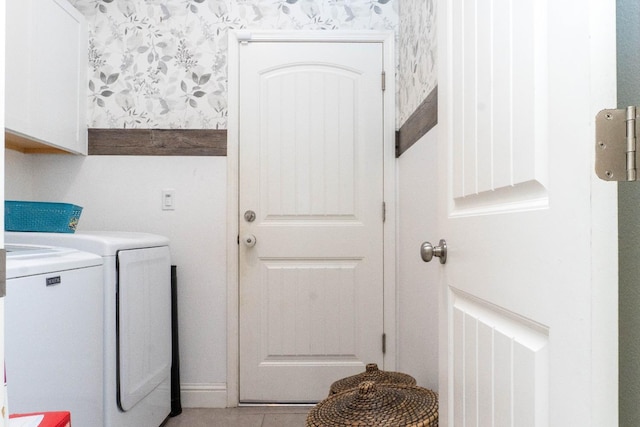 laundry room featuring cabinets, separate washer and dryer, and light tile patterned floors