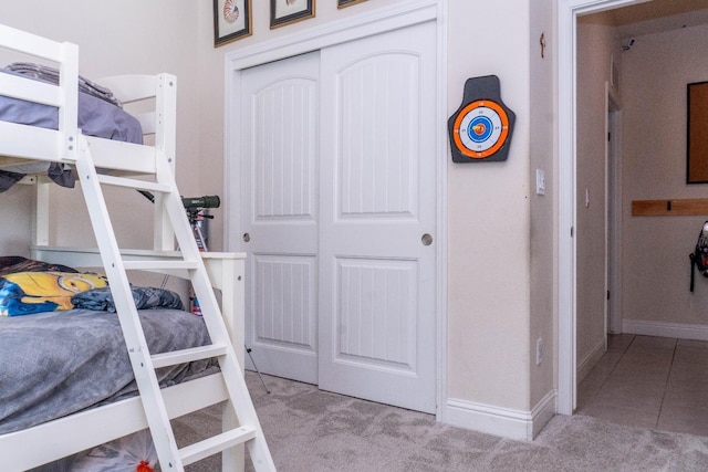 bedroom with light carpet and a closet