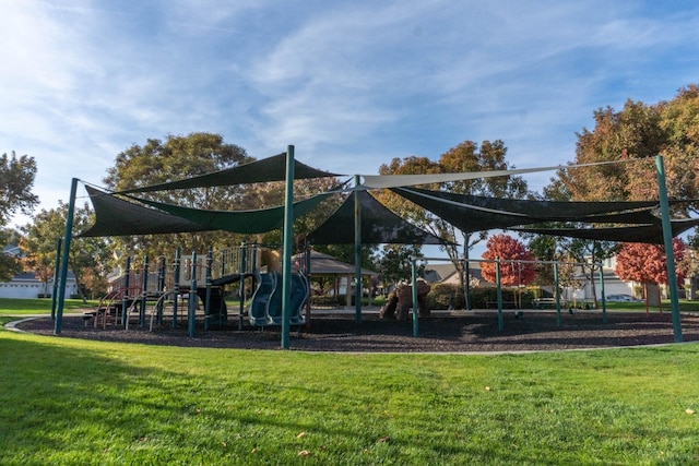 view of playground with a lawn