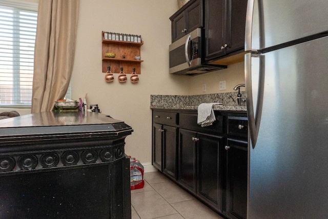 kitchen featuring sink, light tile patterned flooring, and appliances with stainless steel finishes