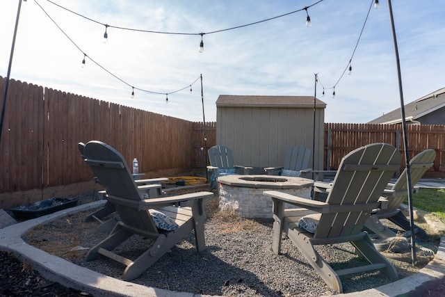 view of patio / terrace with a shed and an outdoor fire pit