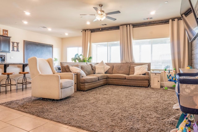 living room featuring light tile patterned floors and ceiling fan