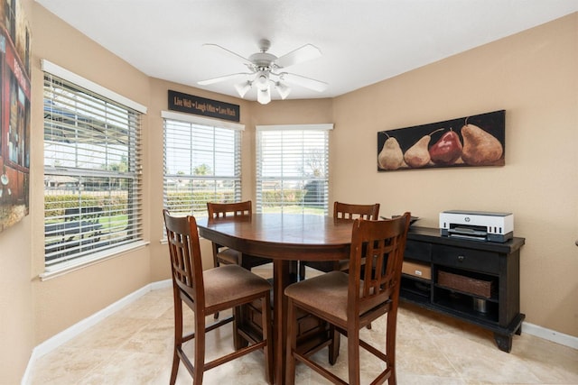 tiled dining area featuring ceiling fan