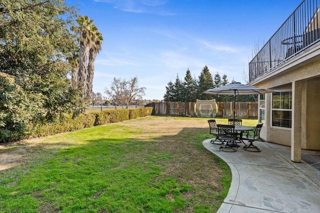 view of yard with a patio and a trampoline