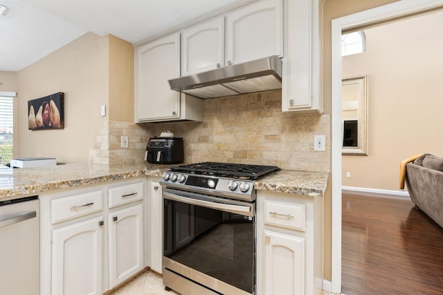 kitchen with white cabinetry, light stone counters, tasteful backsplash, and appliances with stainless steel finishes