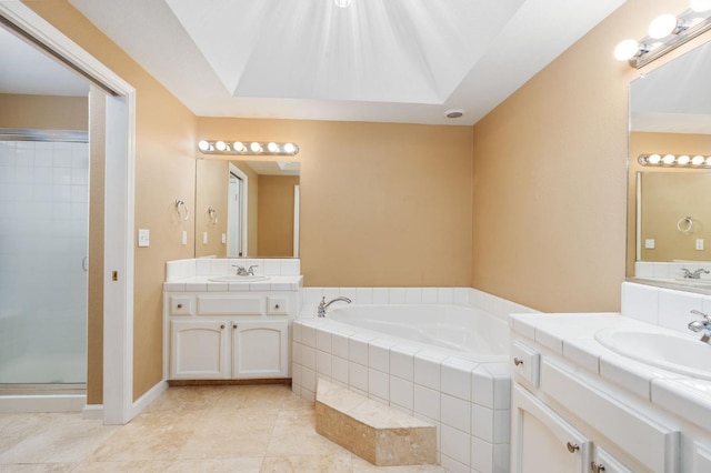 bathroom featuring plus walk in shower, vanity, and tile patterned floors