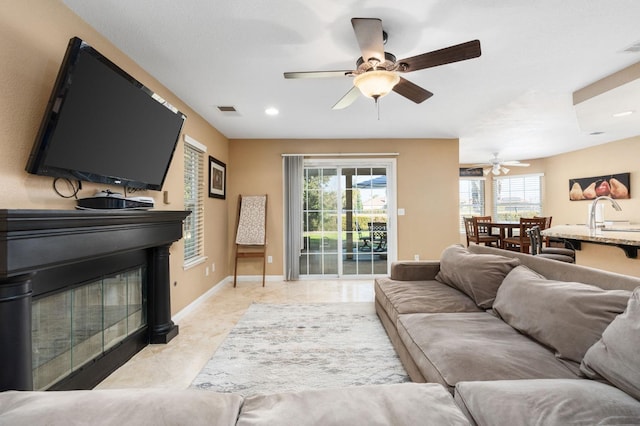 living room featuring ceiling fan and light tile patterned floors