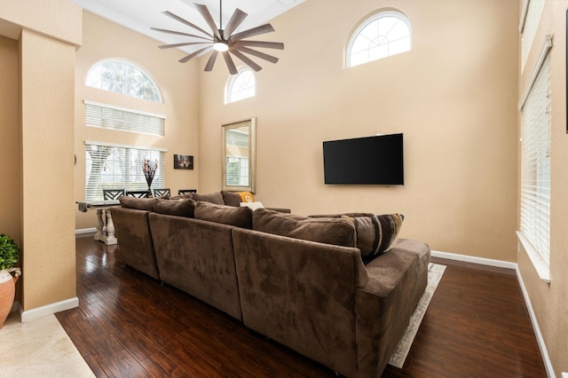 living room featuring a towering ceiling and wood-type flooring