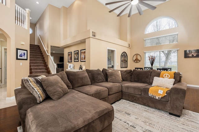 living room featuring hardwood / wood-style flooring, ceiling fan, and a wealth of natural light