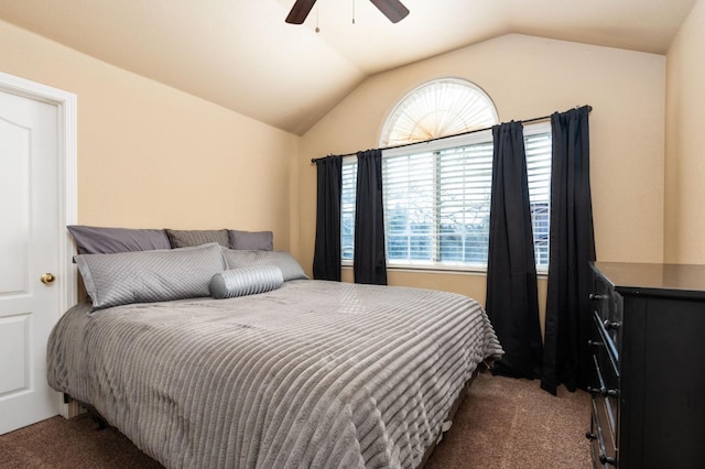 bedroom featuring vaulted ceiling, ceiling fan, and dark colored carpet