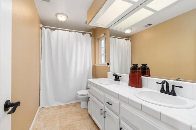 bathroom featuring tile patterned flooring, vanity, and toilet