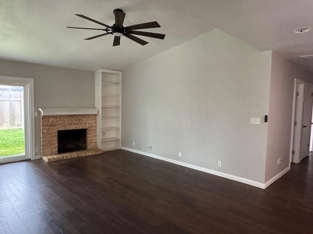 unfurnished living room featuring a brick fireplace, ceiling fan, baseboards, and dark wood-style flooring