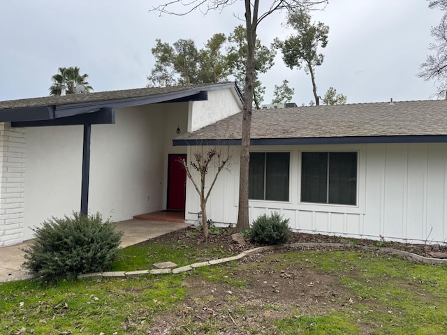 entrance to property with a yard