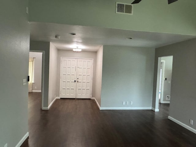 entrance foyer featuring dark wood-type flooring, visible vents, and baseboards