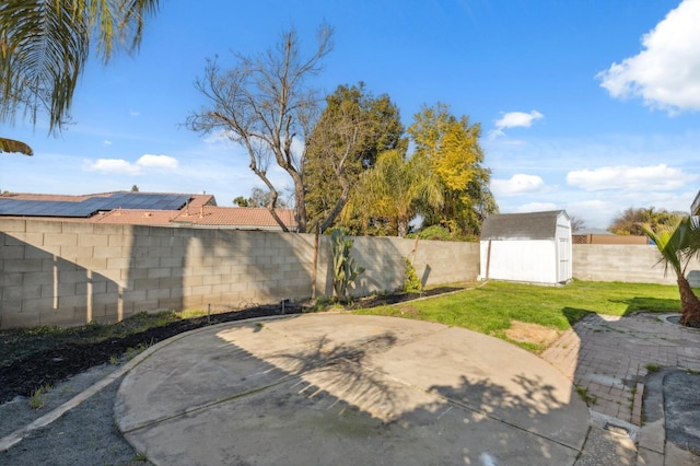 view of yard featuring a shed and a patio area