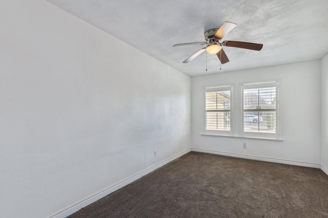 unfurnished room featuring dark colored carpet and ceiling fan