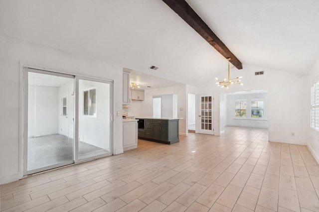 unfurnished living room with lofted ceiling with beams, a chandelier, and light hardwood / wood-style flooring