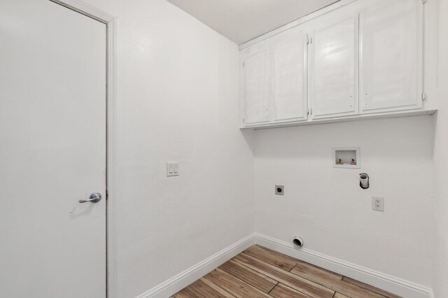 washroom featuring cabinets, hookup for a washing machine, hookup for an electric dryer, and light wood-type flooring