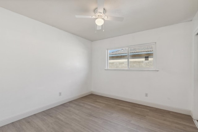 empty room featuring light wood-type flooring, ceiling fan, and baseboards