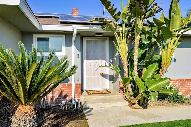 doorway to property featuring solar panels