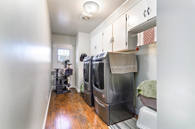 clothes washing area featuring cabinets, dark hardwood / wood-style floors, and separate washer and dryer