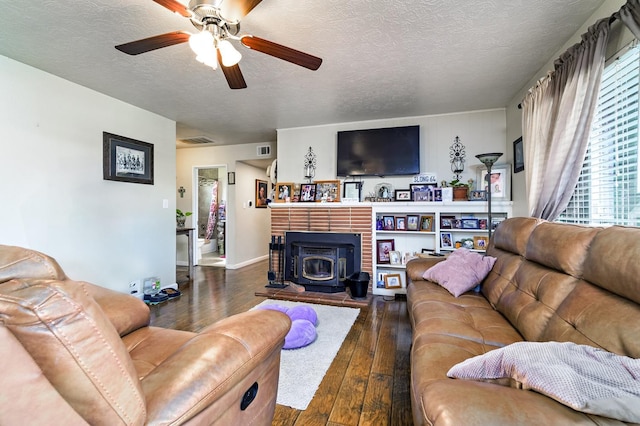 living room with ceiling fan, dark hardwood / wood-style floors, and a textured ceiling