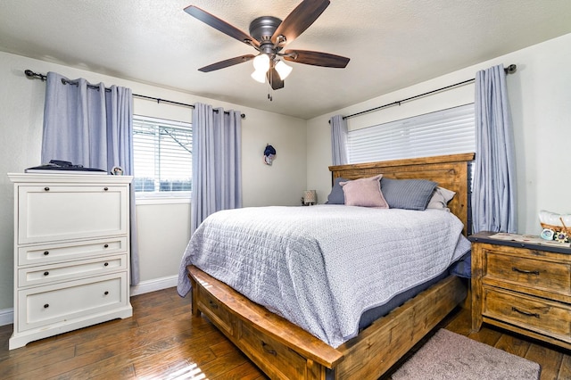 bedroom featuring ceiling fan, dark hardwood / wood-style floors, and a textured ceiling