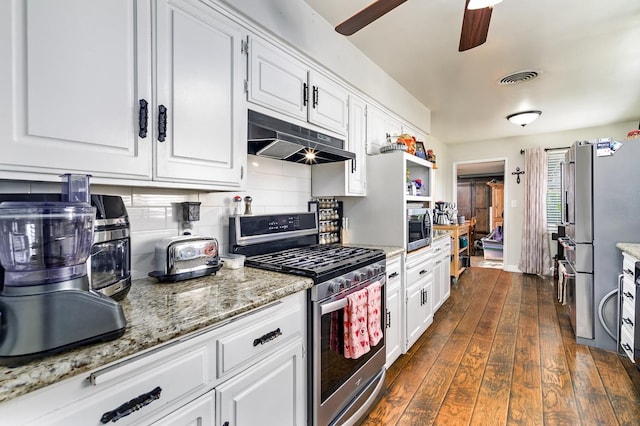 kitchen with tasteful backsplash, white cabinets, dark hardwood / wood-style flooring, stainless steel appliances, and light stone countertops